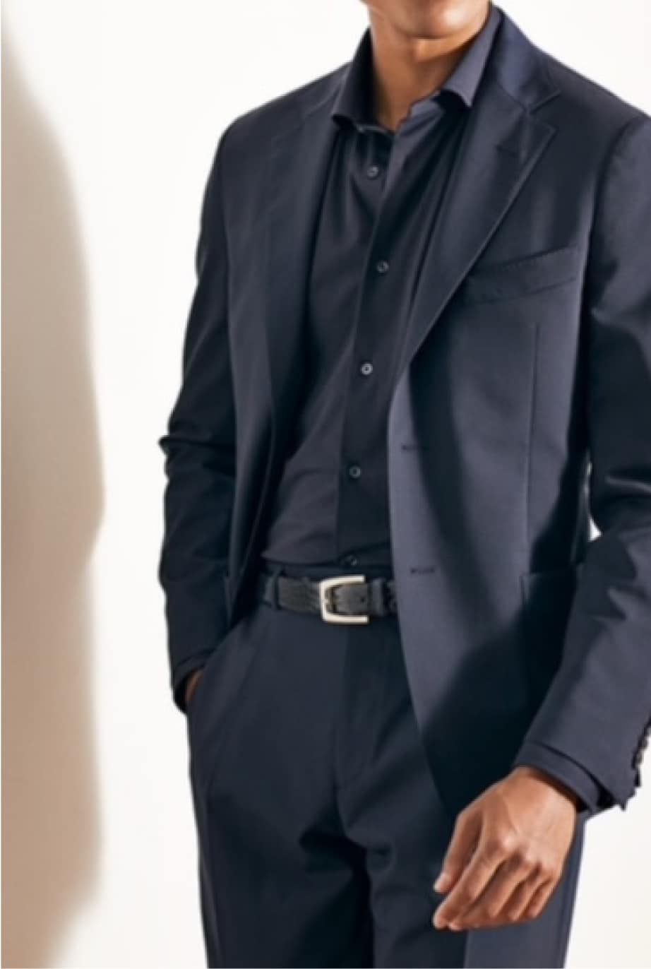 Male model wearing a tailored Deletto Milano suit in a stylish indoor setting